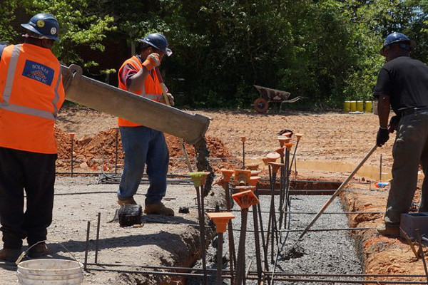 workers pouring a foundation