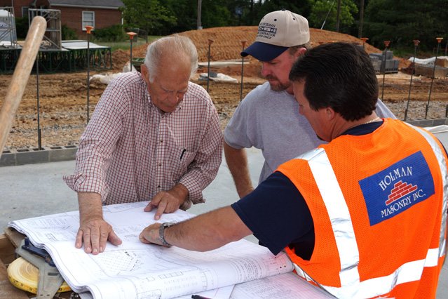 Holman staff reviewing building plans