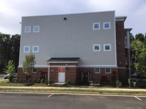 Left side of the apartment buildings.